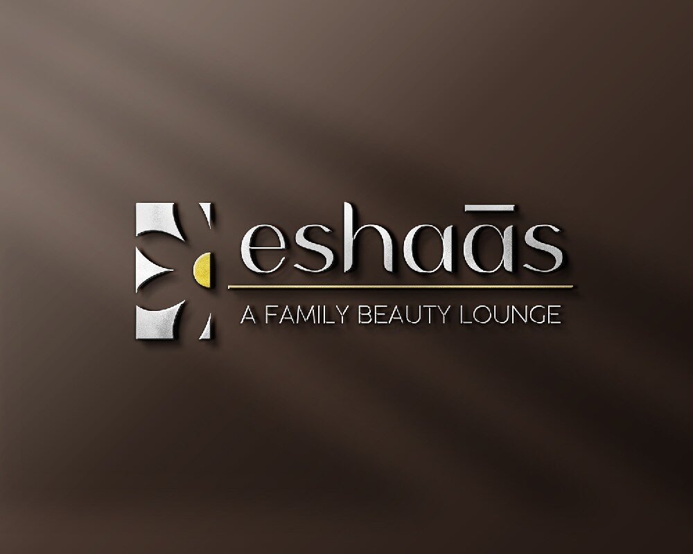 Eshaas embossed logo on a brown textured surface