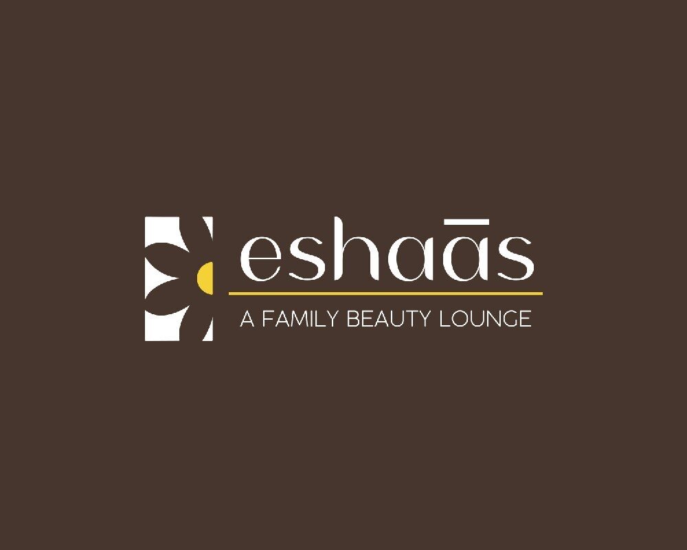 Eshaas a family beauty lounge logo reversed on brown